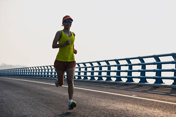 istock Fitness woman runner running on seaside bridge 2249724054