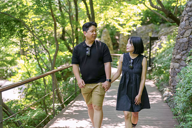 istock A man and woman are walking on a path in a forest 2249724686