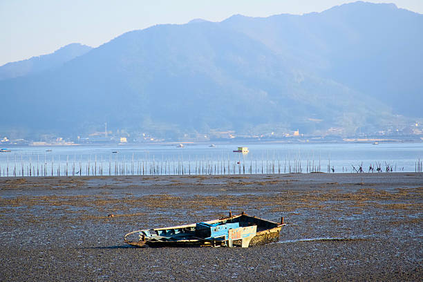 istock A boat that fell into the mudflats in the evening 2249725034