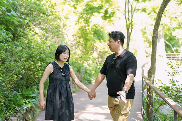 istock A man and woman are walking together on a path in a park 2249725199
