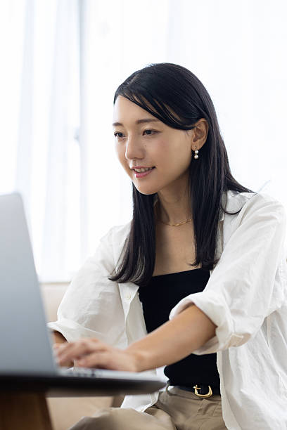istock Smiling Woman Working on Laptop at Home 2249725482