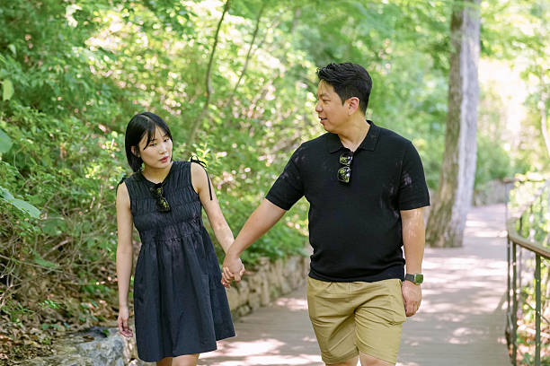 istock A man and woman are walking on a path in a park 2249725529