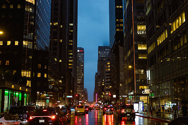 istock Cityscape at Dusk: Busy Urban Street with Rainy Reflections 2249725923