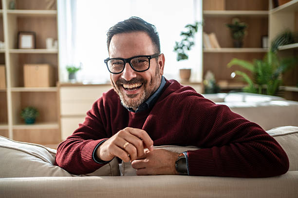 istock Happy man with glasses laughing at home 2249726007