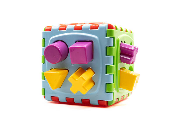 istock Children's sorting toy, puzzle for sorting shapes into appropriate holes, isolated on white background. Child development concept. Colorful toys 2249727839