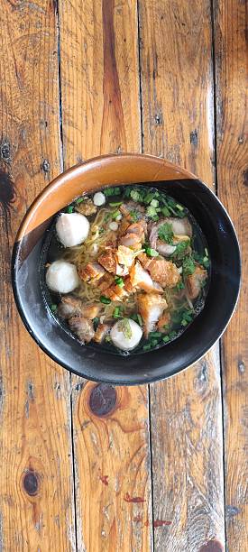 istock Noodle soup in a ceramic bowl on a wooden table 2249729182
