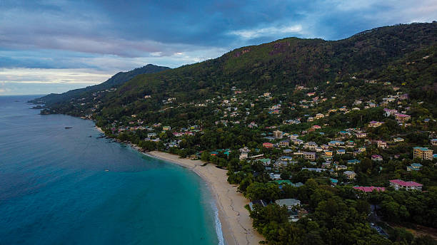 istock High-Angle Drone Shot: Forested Mountains Meeting the Clear Ocean Water 2249730145