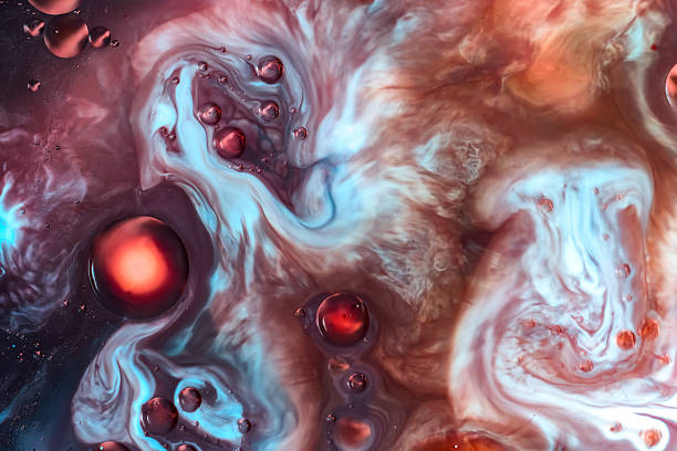 istock Abstract liquid macro with swirling red, blue and white drops, marbled organic surface, cosmic artistic texture 2249730554