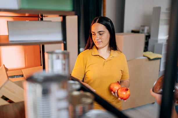 istock Young female volunteer packing items 2249731679