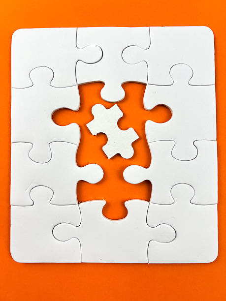 istock A conceptual puzzle photography with interlocking white puzzle pieces, some connected and some isolated, set against a vibrant yellow backdrop. 2249731852