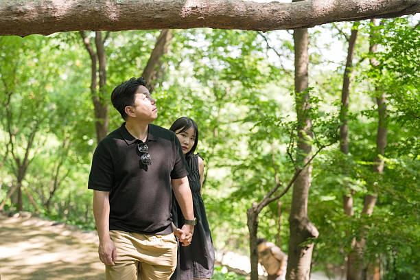 istock A man and a woman are walking in a forest, holding hands 2249732396