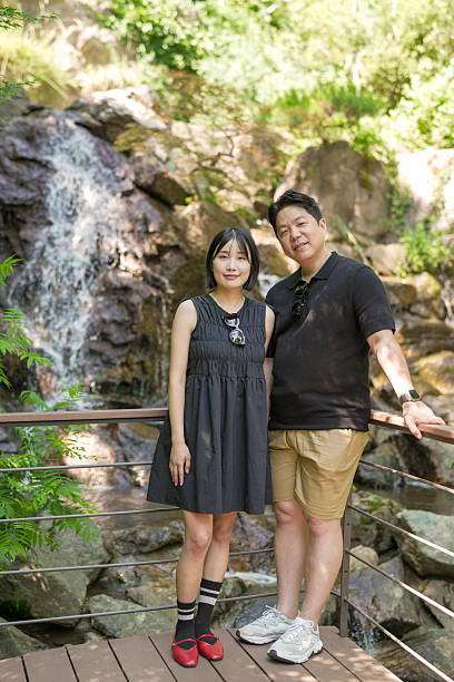 istock A man and woman stand on a bridge overlooking a waterfall 2249733782