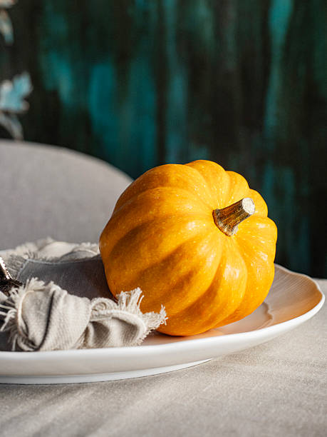 istock Pumpkins. Orange pumpkin on background for halloween or thanksgiving. Thanksgiving table setting. 2249735570
