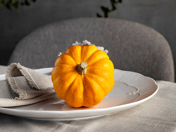istock Pumpkins. Orange pumpkin on background for halloween or thanksgiving. Thanksgiving table setting. 2249735669