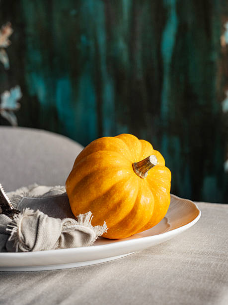 istock Pumpkins. Orange pumpkin on background for halloween or thanksgiving. Thanksgiving table setting. 2249735821