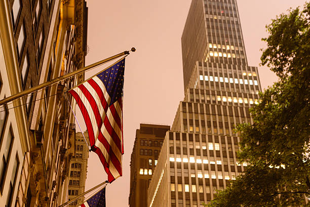 Photograph of a New York street with American flags and classic architecture