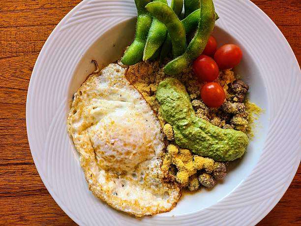 Vegetarian Rice Bowl with Egg, Beans, Cherry Tomatoes, Edamame, and Pesto