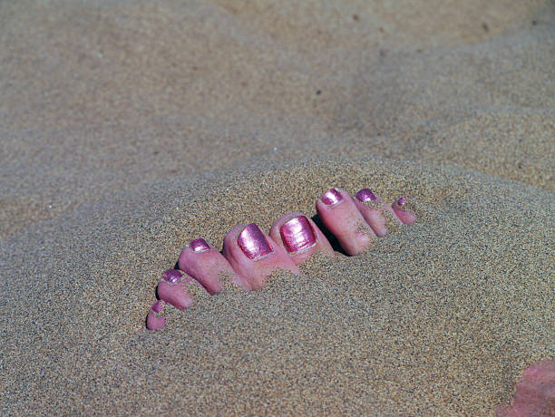 The sands of the Gobi Desert are blistering hot - on the surfaace. Just a few inches below it's cool and refreshing. Bury your hands and feet to cool off, like this woman discovered. Western China, 2013