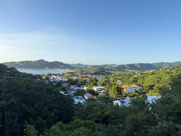 istock Overlooking a tranquil coastal town surrounded by lush green hills 2249740425