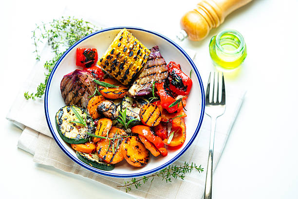 istock Freshly prepared mixed grilled vegetables plate on white background. Eating healthy vegetarian meal, food rich in vitamins and dietary fiber 2249741384