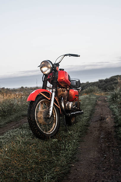 istock classic motorcycle showcased on muddy trail with glowing headlamp and textured chrome surface 2249741441