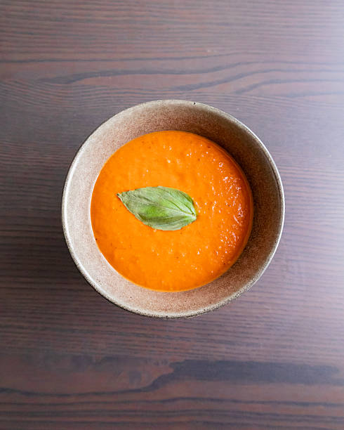 istock creamy roasted tomato and red pepper soup with fresh basil in black bowl 2249741480