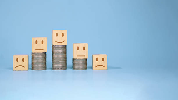 istock Customer Feedback and Financial Performance Concept with Wooden Faces and Coin Stacks 2249741924