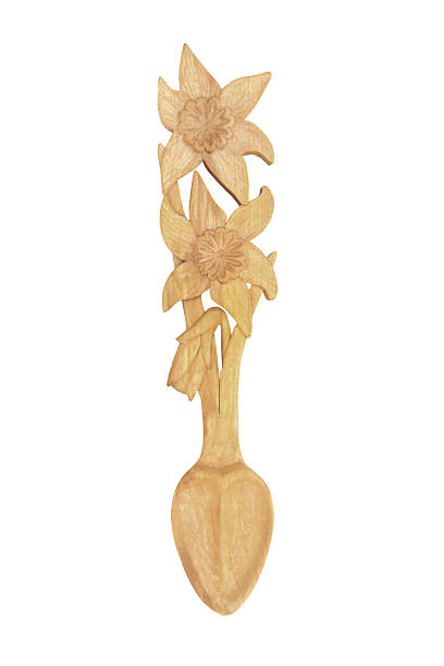 four wooden spoons on wooden floor.