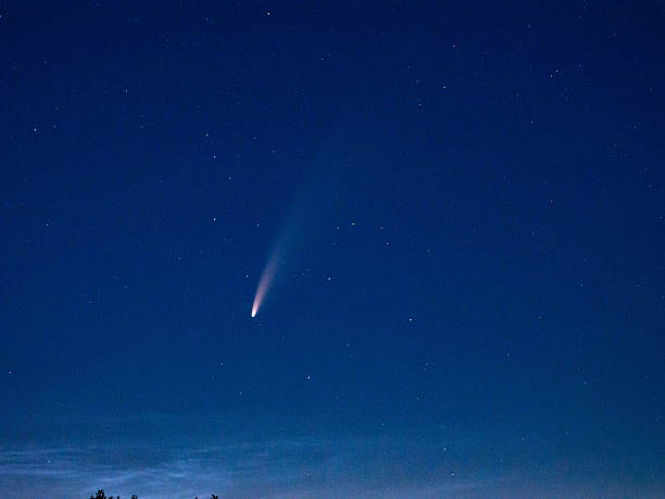 istock lone comet journey, solitary comet gracefully streaking across evening celestial canvas with stars 2249743603