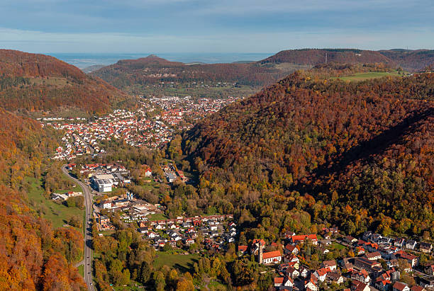 istock German city in a valley surrounded by autumn deciduous forest, above view 2249744283