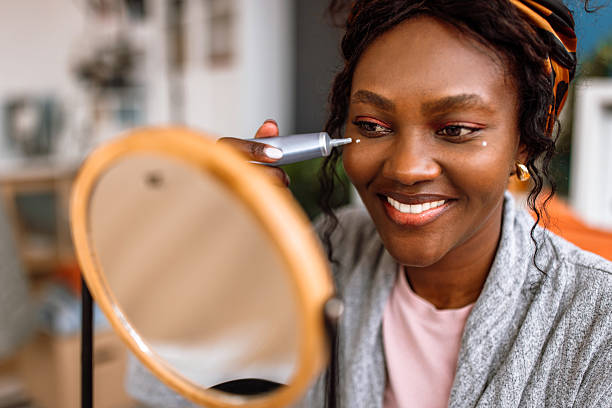 istock Woman applying moisturiser on face during morning routine 2249744309