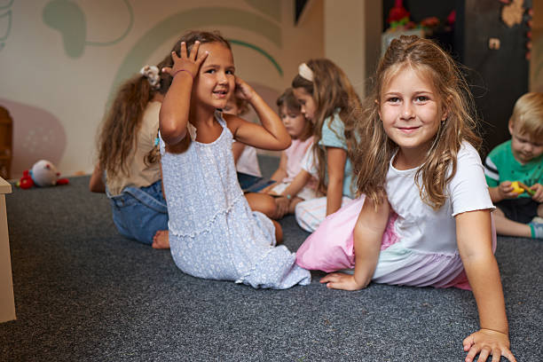 Group of smiling children having fun playing together on the floor