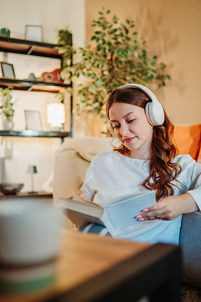 istock Woman reading book at home enjoying quiet leisure time 2249745590