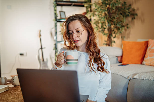istock Woman relaxing working on laptop at home 2249745660