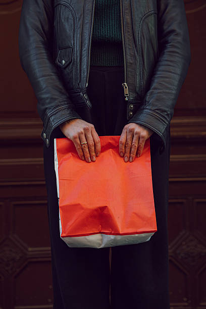 istock Hands holding red food delivery bag with space for text 2249747110