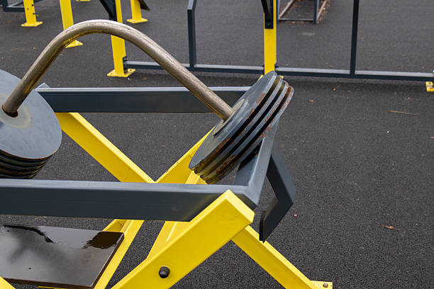 istock Heavy weight plates rest on a sturdy outdoor gym frame designed for strength training in a public fitness area under bright sunlight 2249747688