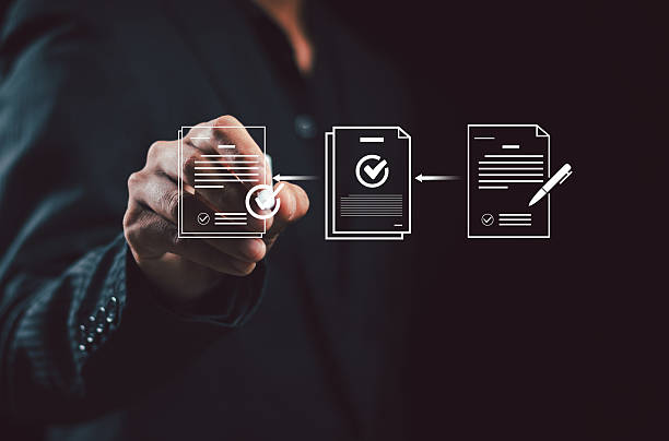 istock Businessman using electronic pen sign tick mark on virtual document for online approve paperless quality assurance and ERP management , Prepare check and approve document concept. 2249747867