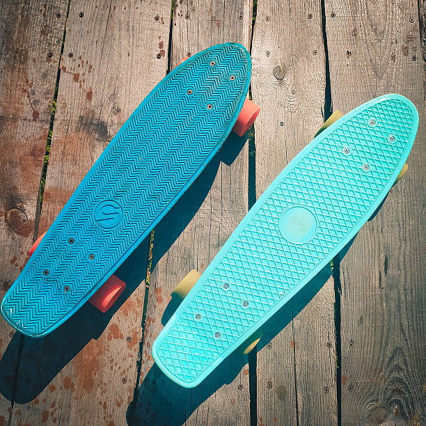 istock beach skateboards relaxing, brightly colored skateboards on wooden surface beneath warm sunlight 2249751244