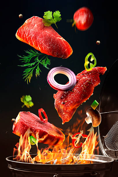 istock Fresh meat and vegetables flying above barbecue grill against black background 2249755111