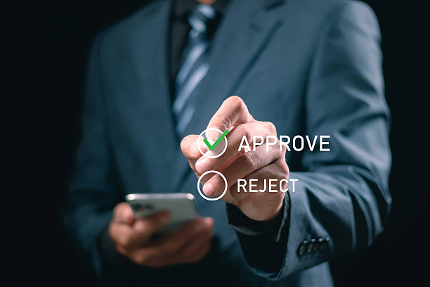 istock Businessman putting a valid check mark in the check box to approve documents and project ideas 2249755403