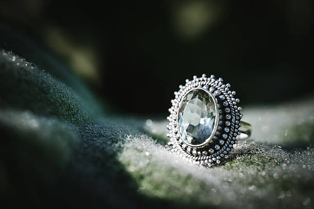 Wedding golden diamond ring on rose petals. Black and white