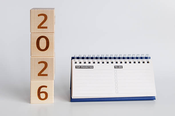 istock Wooden blocks marked with year 2026 stand beside spiral-bound notepad featuring to-do list and priorities section for effective planning and organization. 2249756309