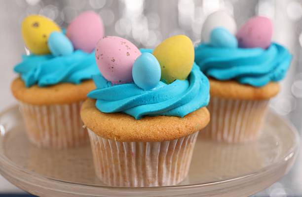 istock Tasty decorated Easter cupcakes on stand, closeup 2249758432