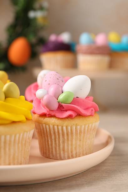 istock Tasty decorated Easter cupcakes on wooden table, closeup 2249758451