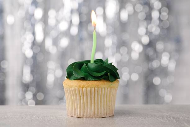 istock Delicious cupcake with bright cream and burning candle on grey table, closeup 2249758458