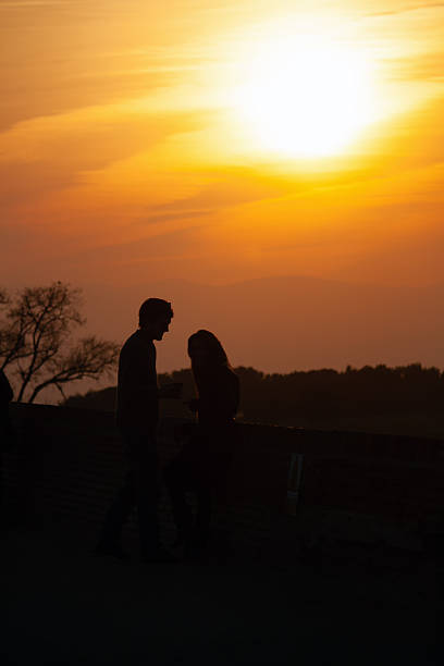 a couple is enjoying the sunset in Barcelona (Spain)