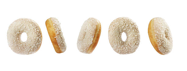 istock Delicious coconut-covered donuts arranged in a tempting display on a white background 2249760073