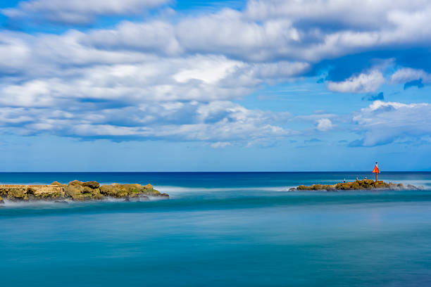 istock Inlet rocks at Boca Raton Florida. Long exposure for smooth water and motion blur in sky 2249762933
