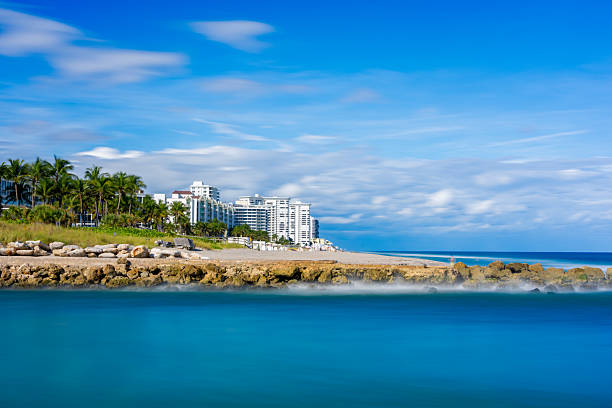 Bonita Springs, Florida, USA - Waterfront buildings on a white sand beach. People enjoying the white sand beach.