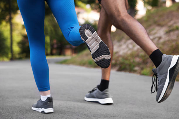 Couple in sneakers running in park, closeup